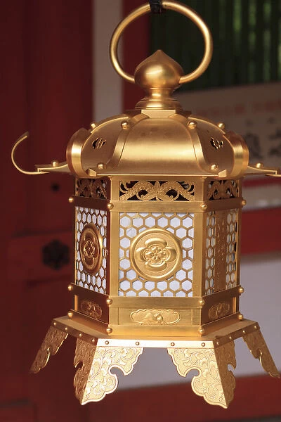 Smaller metal and gold lanterns are representations of their ancient stone siblings