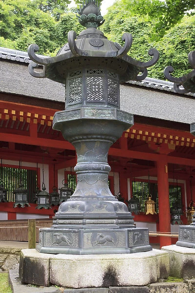 Smaller metal and gold lanterns are representations of their ancient stone siblings