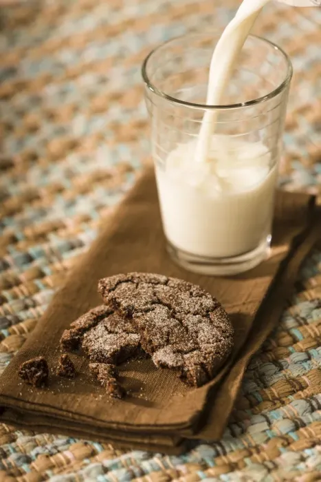 Framed Print : Snack of a homemade chocolate sugar cookie, with milk being poured into a glass Framed Print : Snack of a homemade chocolate sugar cookie, with milk being poured into a glass