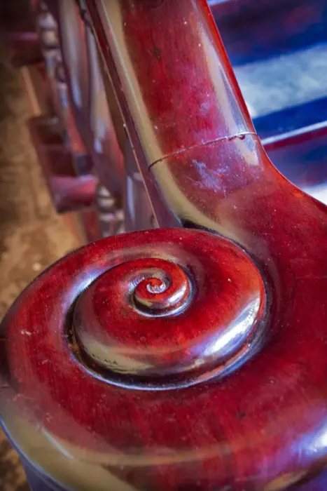 Framed Print : Snail shell-like curve on red wooden bannister handrail in Trinidad, Cuba
