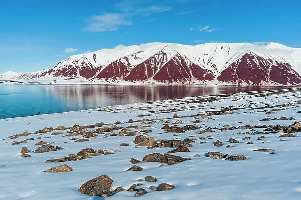 Snow covered rock beaches and mountains rim Bockfjorden, Spitsbergen Island, Svalbard, Norway