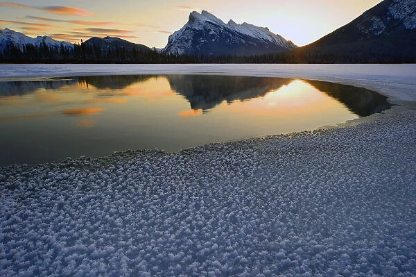 Snow crystals rim a lone break in the ice on Vermilion Lakes on a cold Banff National