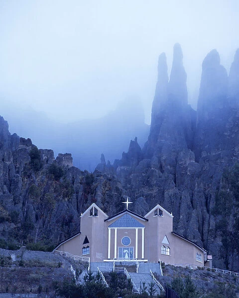 South America, Bolivia. Modernistic church nestled in the mountainous badlands above La Paz