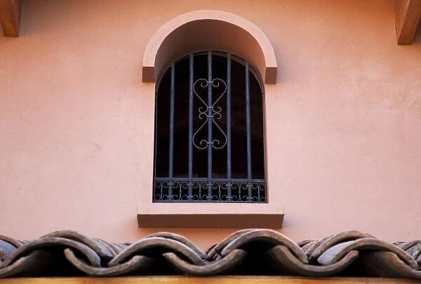 South America, Chile, Lo Abarca. Wrought iron window and roof tiles at Casa Marin Winery