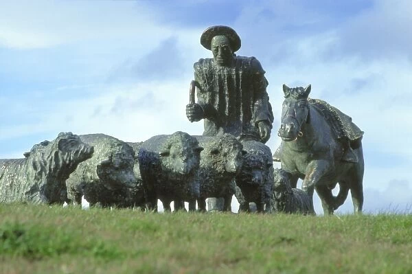 South America, Chile, Punta Arenas. This bronze monument of a shepherd with sheep