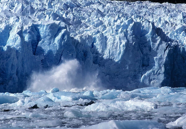 South America, Chile, San Rafael Lagoon NP. A newly-calved iceberg splashes against