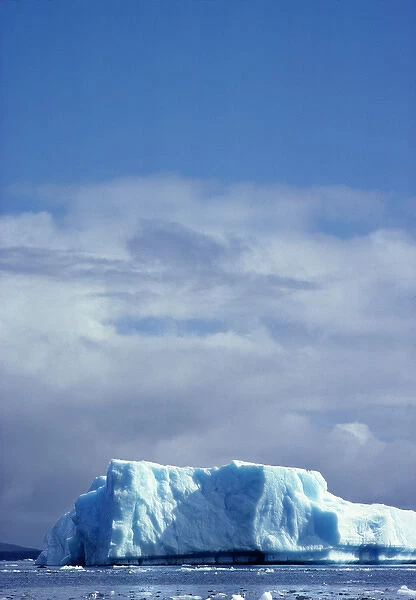 South America, Chile, San Rafael Lagoon NP. An iceburg shaped like a blue mesa rises