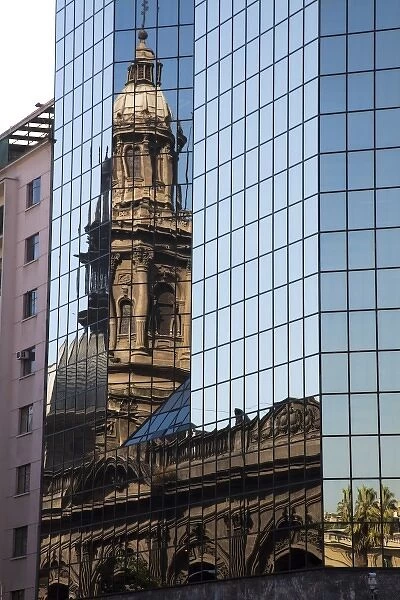 South America, Chile, Santiago. Reflection of a cathedral in a building near the Plaza de Armas