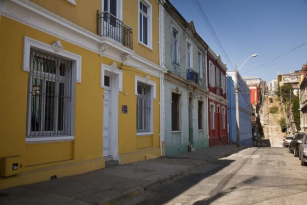 South America, Chile, Valparaiso. Colorful houses line a street. (UNESCO World Heritage