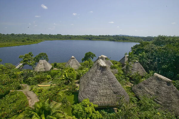 South America, Ecuador, Napo Wildlife Center. Overview of thached huts and lake. Credit as