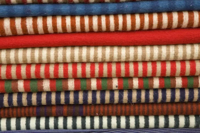Framed Print : South America, Ecuador, Saquisili, stack of ponchos at weekly food and crafts market