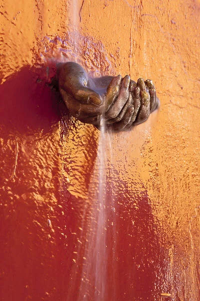 South America, Mexico, San Miguel de Allende. Fountain detail of water dropping in cupped hands