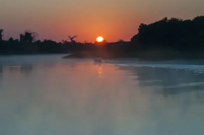 Framed Print : South America, The Pantanal, Brazil, A lone boat at sunrise driving through the rising
