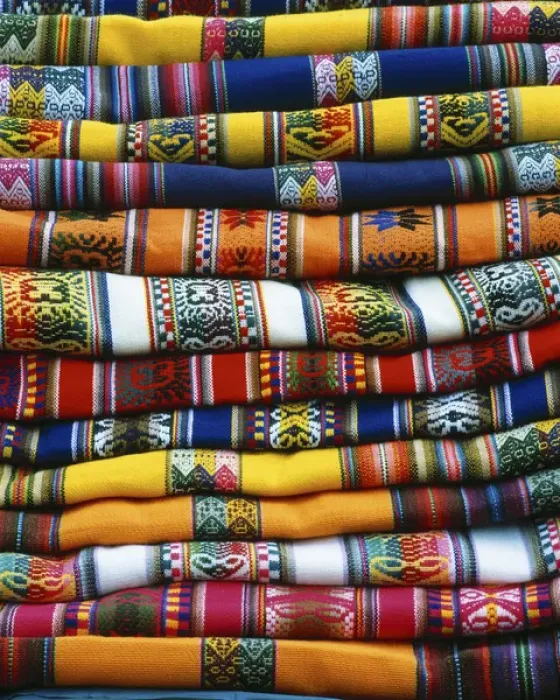 Framed Print : South America, Peru, near Cusco. Stack of colorful blankets for sale in market. Credit as