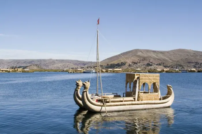Framed Print : South America - Peru. Reed boat moving through channel along a floating island
