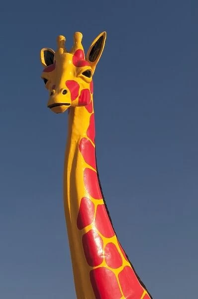 South Carolina, USA. A colorful Giraffee sculpture at the Mexican themed South of