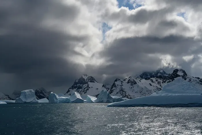 Framed Print : South Georgia Island. Sculpted blue icebergs floating in the Atlantic and mountain scenery