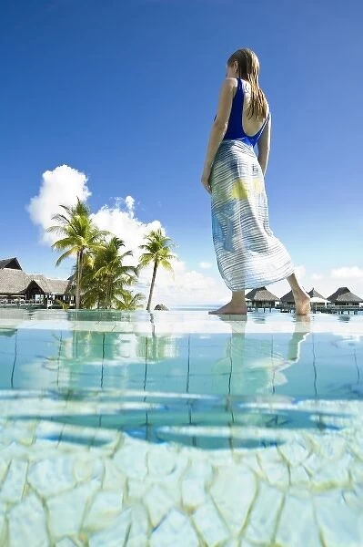 South Pacific, Bora Bora, female tourist relaxing at resort. (MR)