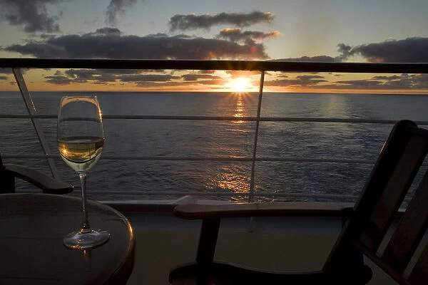South Pacific, French Polynesia, Cook Islands, Rarotonga. Sunset and wine aboard the Paul Gauguin