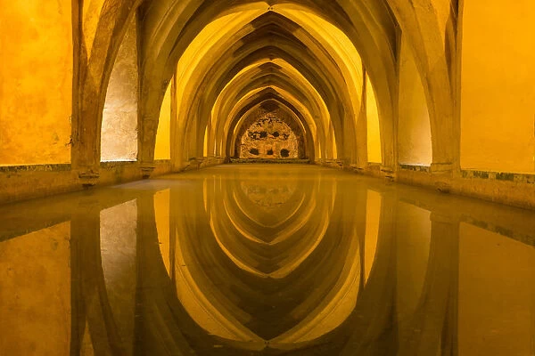 Spain, Andalusia, Seville. The repeating arches of the interior of the baths reflect
