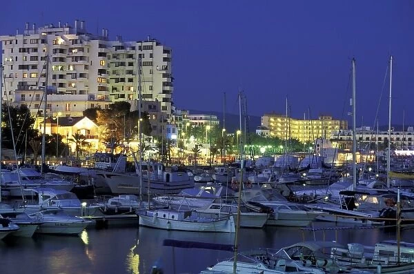 Spain, Balearics, Ibiza, Sant Antoni de Portmany. Evening view of city and marina