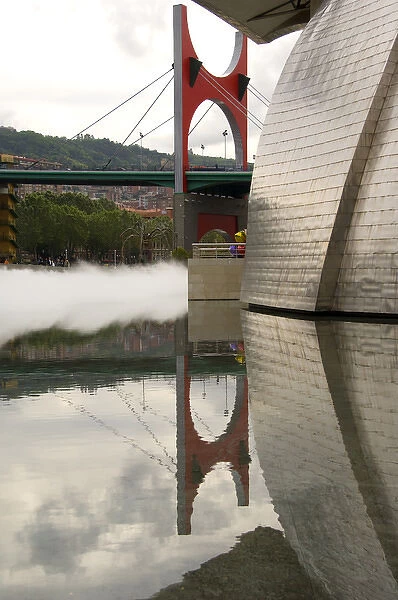 Spain, Bilbao. Guggenheim Museum with mist & bridge reflections