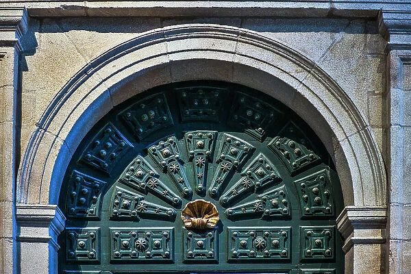 Spain, Galicia. Cathedral in Santiago de Compostela, doorway highlighting the scallop shell (symbol of the pilgrimage)
