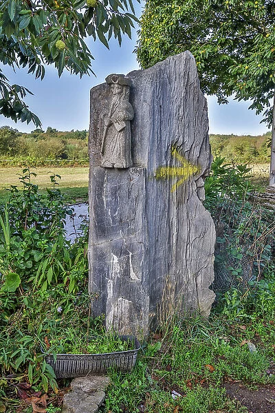 Spain, Galicia. Stone carving of a pilgrim along the Camino de between Ventras de Naron and Palas de Rei