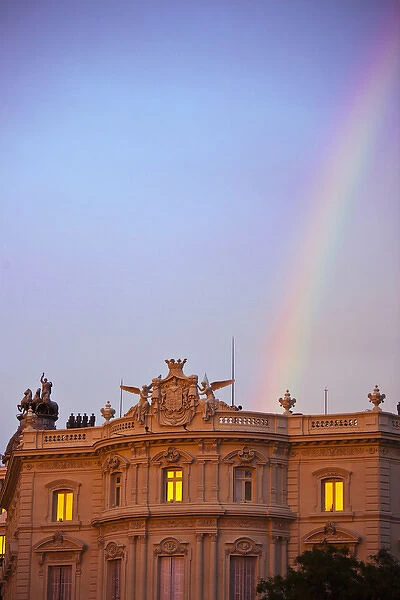 Spain, Madrid, Plaza de Cibeles, view along Calle de Alcala, rainbow at sunset