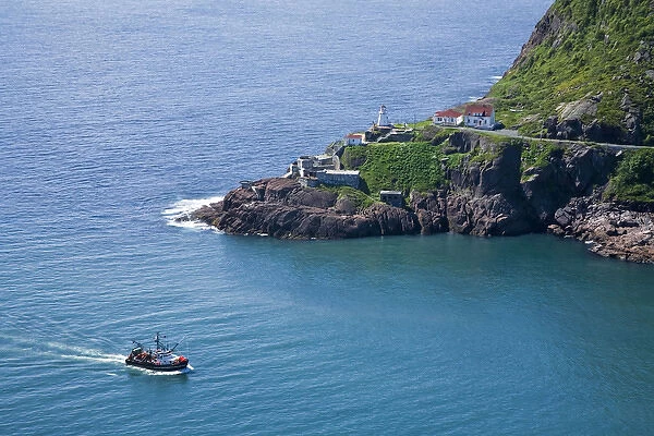 St. Johna's, Newfoundland, Canada, a lobster boat sails by historic Fort Amherst