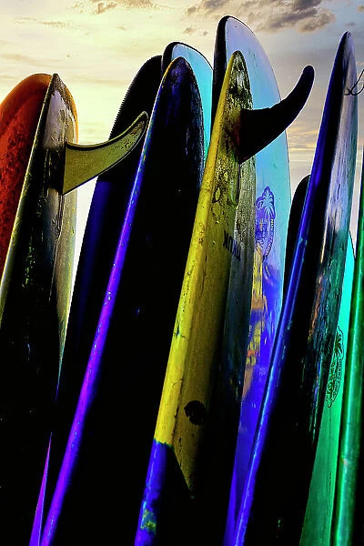 Stacked surf boards at sunset after a day of surf school in Canggu, Bali, Indonesia