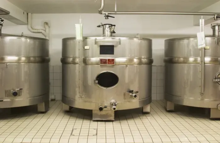 Framed Print : Stainless steel fermentation tanks of an unusual shape wider than they are high