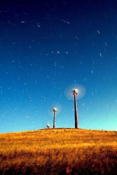 Startrails appearing to be blown by wind turbines under a full moon