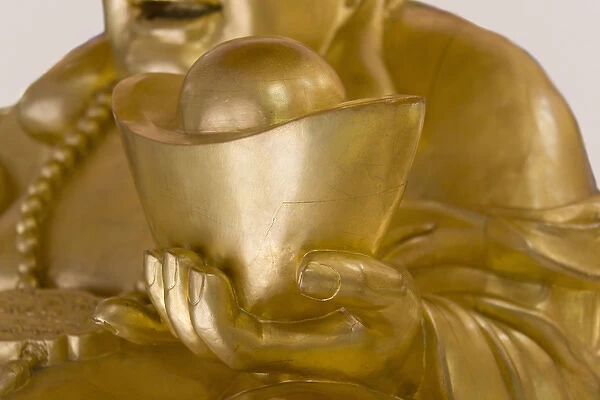 Statue of Laughing Buddha holding gold nuggets, Shanghai, China