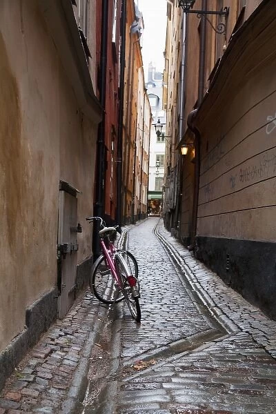 Stockholm, Sweden - A bicycle sitting in a narrow alley going between two old world buildings