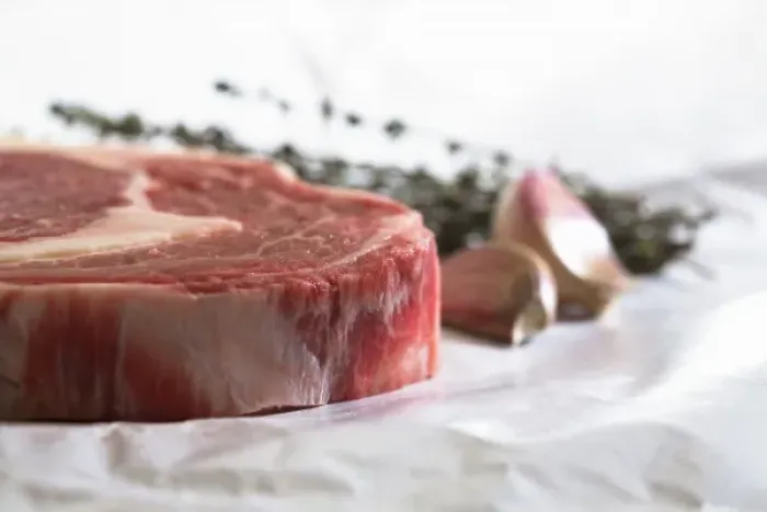 Framed Print : Stockholm, Sweden - Closeup, cropped image of a steak, cloves of garlic and fresh herbs