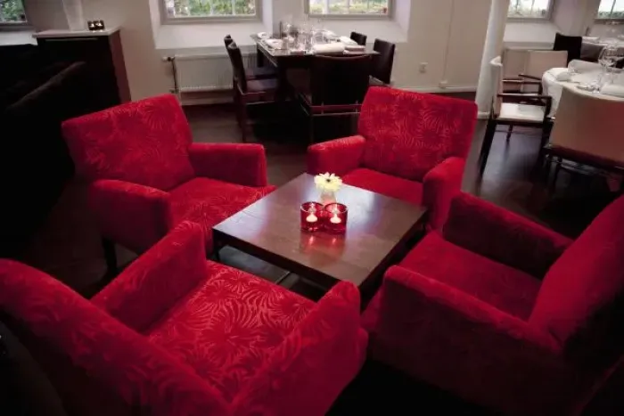 Framed Print : Stockholm, Sweden - High angle view of four red chairs around a small coffee table Framed Print : Stockholm, Sweden - High angle view of four red chairs around a small coffee table