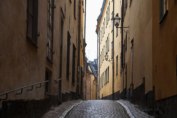Stockholm, Sweden - A narrow alley going between two old world buildings. Horizontal shot