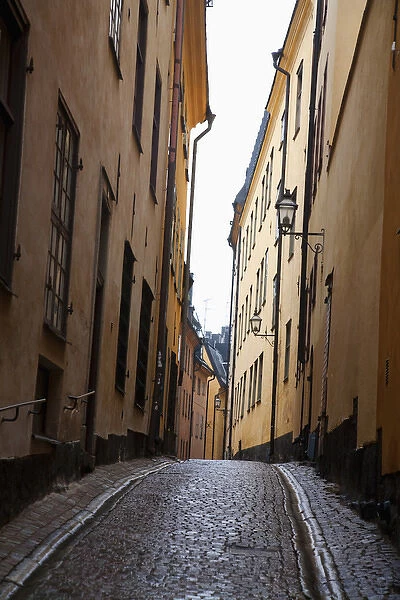 Stockholm, Sweden - A narrow alley going between two old world buildings. Vertical shot