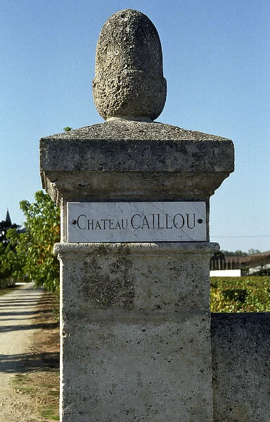 The stone gate post at the entrance to the chateau with a marble plaque inscribed
