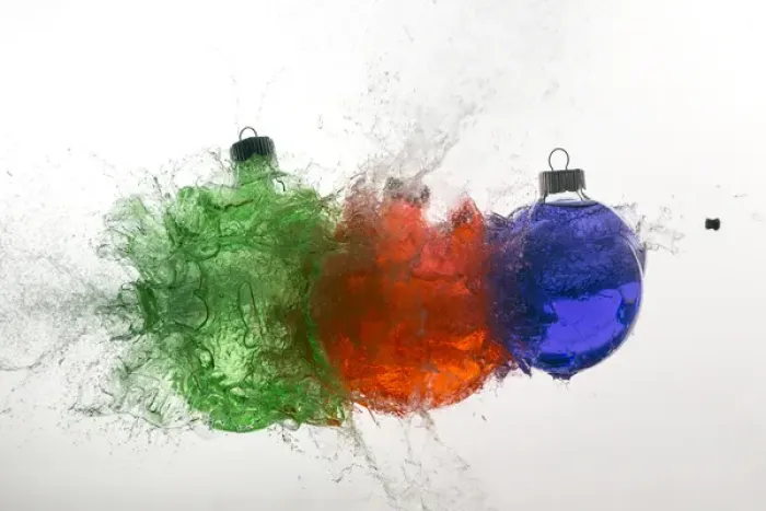 Framed Print : Stop action of Christmas ornaments filled with colored water and exploding form bullet