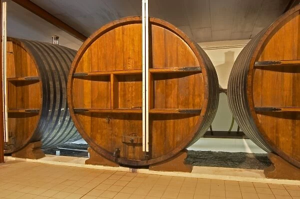 A storage room in the winery with old wooden foudres (large wooden barrels) Chateau
