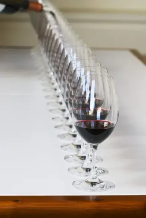 Framed Print : A straight row of glasses lined up for tasting being filled up with red wine - Chateau Framed Print : A straight row of glasses lined up for tasting being filled up with red wine - Chateau