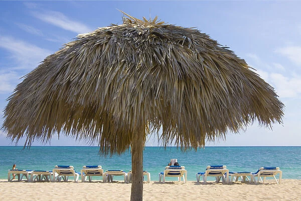 Straw umbrella and chairs on the beach, Trinidad, Cuba