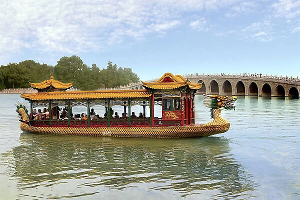 The Summer Palace, Beijing, China, a traditional Dragon Boat passes the Seventeen