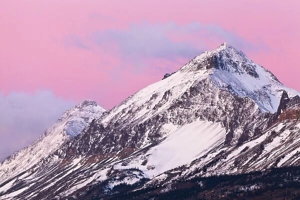 Summit and Little Dog Mountains catch mornings first light at Marias Pass in Glacier National Park