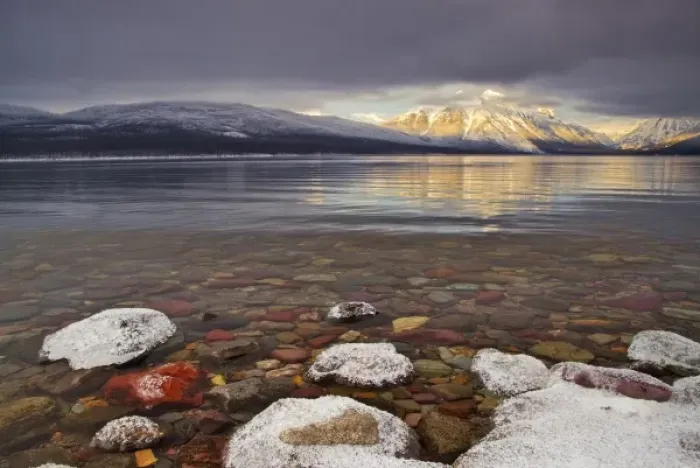 Framed Print : Sun breaks through the clouds at Lake McDonald on a winter evening in Glacier National Framed Print : Sun breaks through the clouds at Lake McDonald on a winter evening in Glacier National