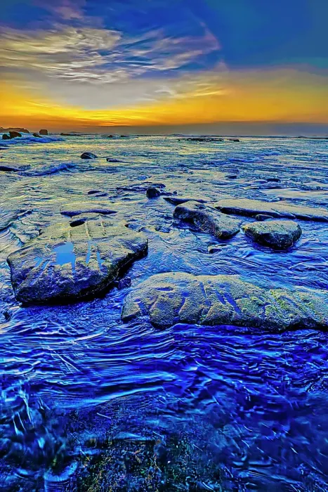 Framed Print : As the sun dips lower on the horizon, its warm, golden light can be absorbed and reflected by the black sand, intensifying the colors and creating a rich, deep contrast