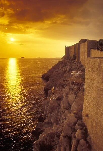 The sun is about to set over the Adriatic Sea outside the old city walls of Dubrovnik, Croatia