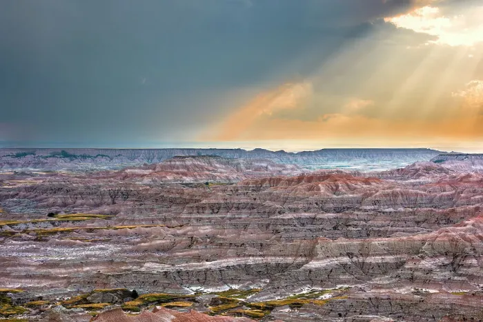 Framed Print : Sunrays over striated, dramatic, badland hills